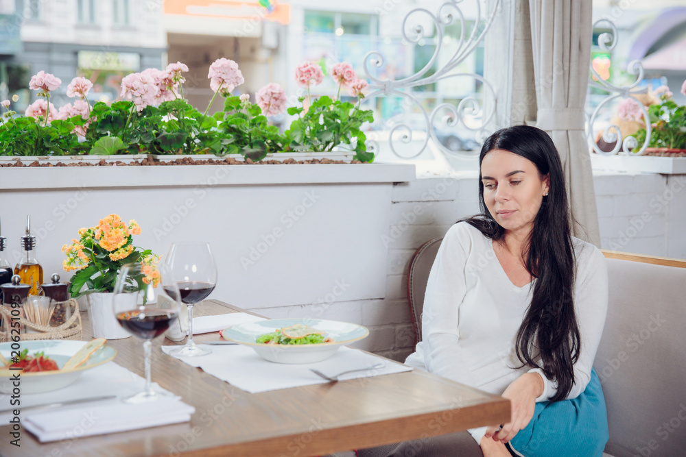 Alone woman in cafe, sad beautiful girl. Attractive bored woman in restaurant. Alone woman in cafe, sad beautiful girl. Attractive bored woman in restaurant.