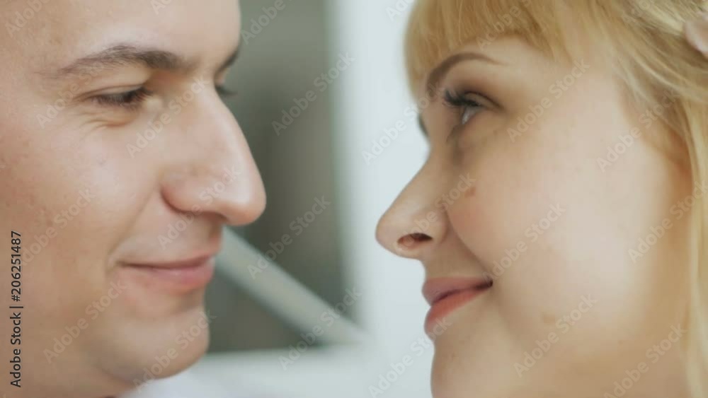 guy kisses his beloved pregnant woman standing at the window guy kisses his beloved pregnant woman standing at the window