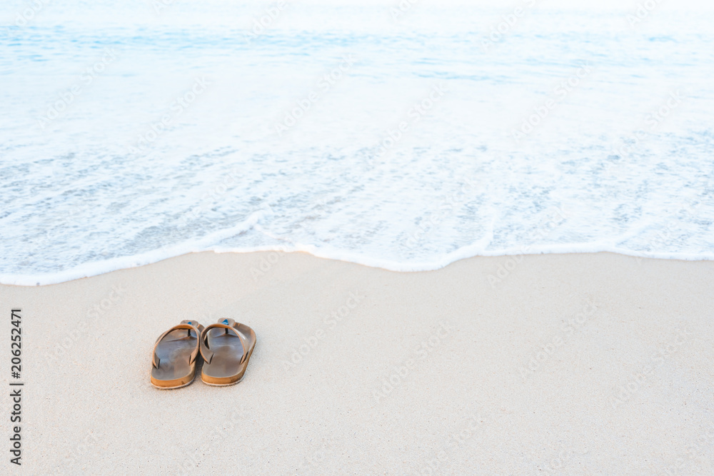 Brown male sandals on tropical sea and beach. Brown male sandals on tropical sea and beach.