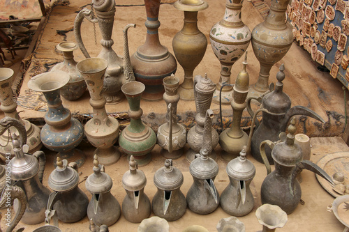 Old metal bedouin coffee pots and jugs for water in one of the markets in Petra,Jordan