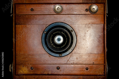 Frontal vintage rare wooden camera projecting light from the inside