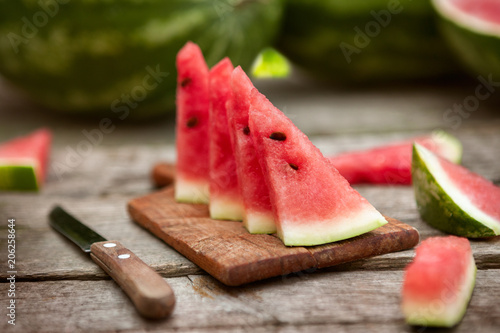 Watermelon slices on chopping board with knife