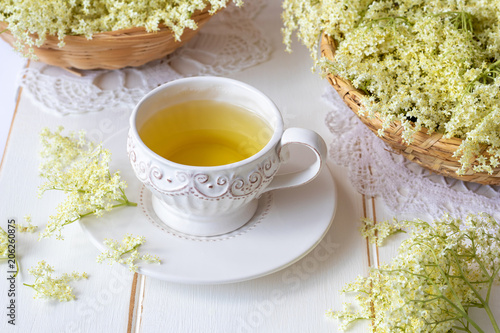 A cup of herbal tea with fresh elder flowers