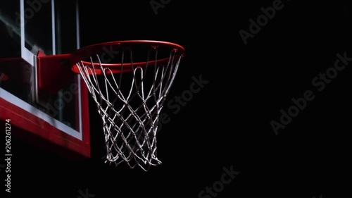 Close up of backward slam dunk on a hoop