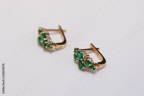 gold earrings with emeralds