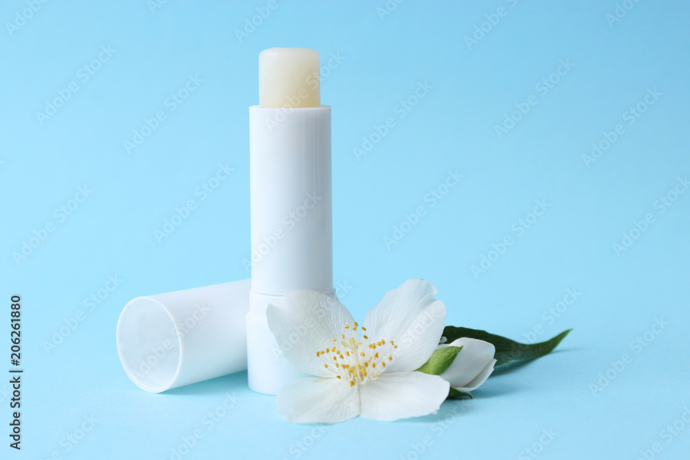 lip balm and flowers on a colored background. minimalism, the top lip balm and flowers on a colored background. minimalism, the top