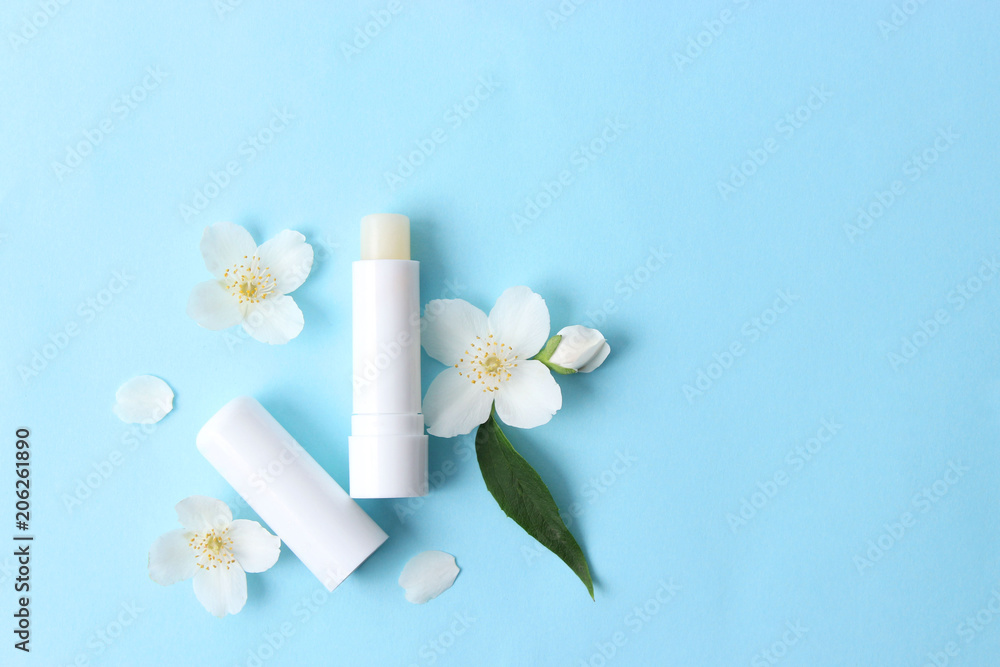 lip balm and flowers on a colored background. minimalism, the top lip balm and flowers on a colored background. minimalism, the top