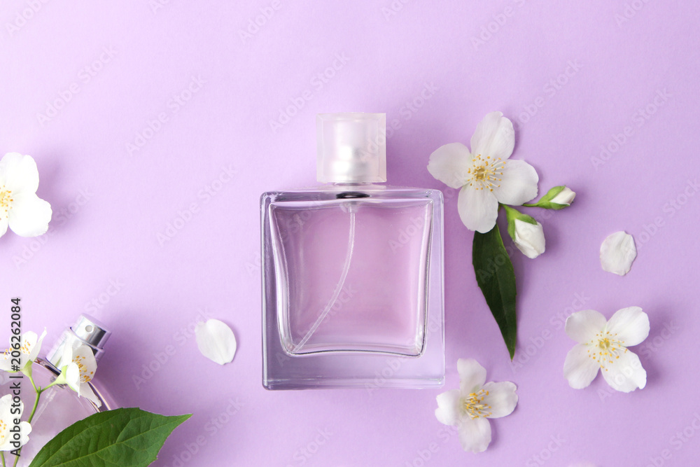 a bottle of perfume and flowers on a colored background. minimalism, top. a bottle of perfume and flowers on a colored background. minimalism, top.