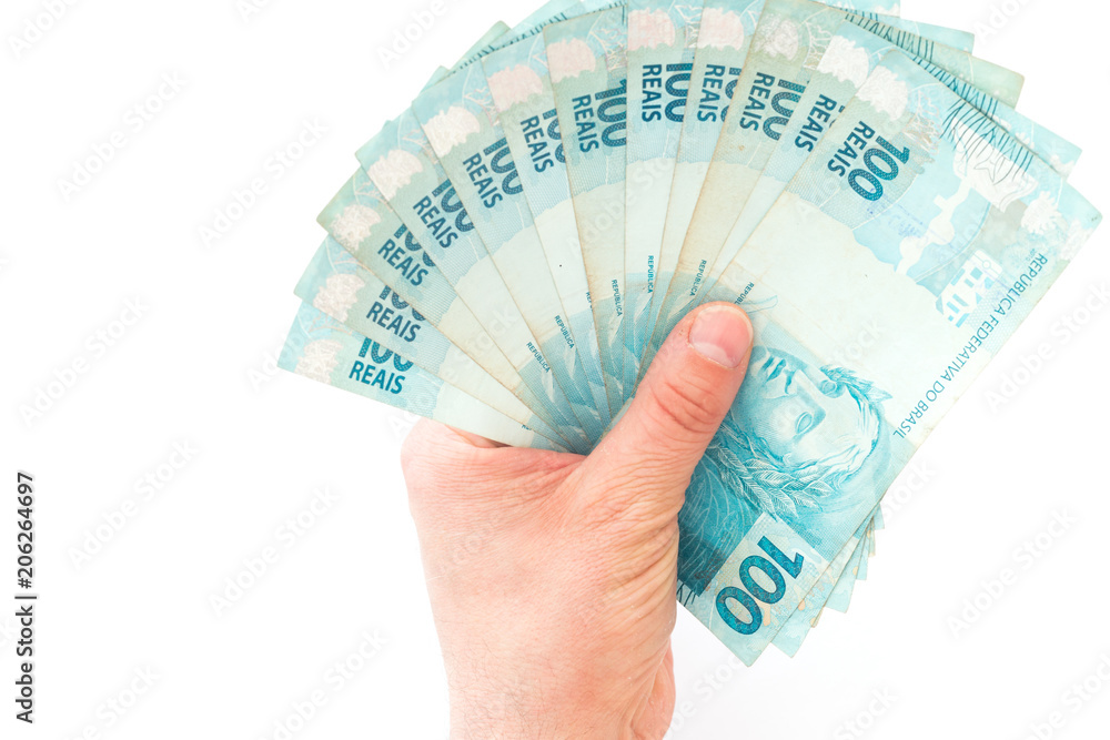 Big amount of brazilian money,  reais, in hand, concept of success.