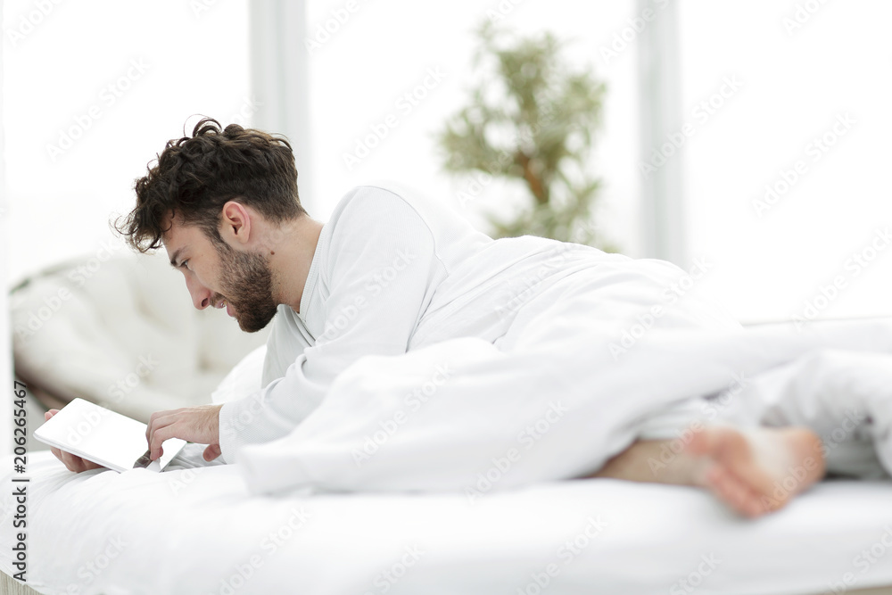 closeup.awakened man typing with a digital tablet closeup.awakened man typing with a digital tablet
