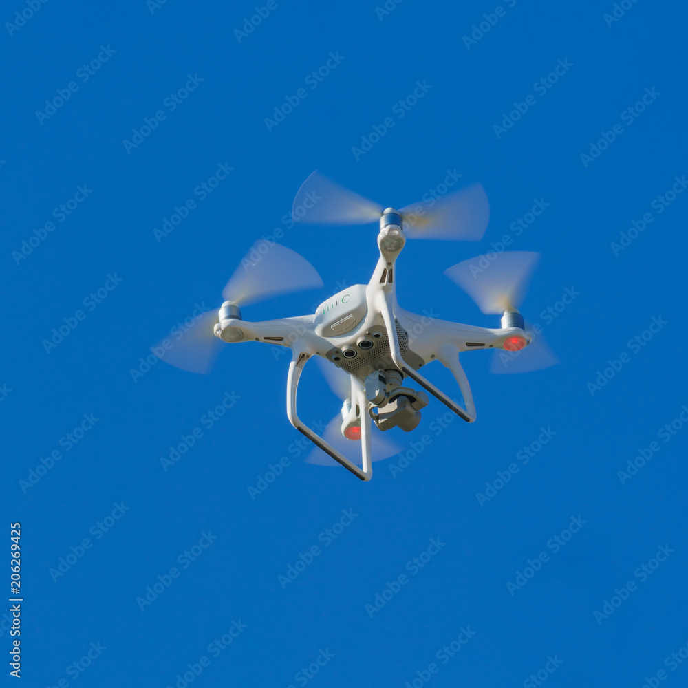 White flying copter against the sky White flying copter against the sky