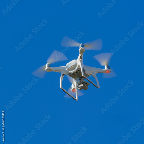 Fototapeta Naklejka Na Ścianę i Meble -  White flying copter against the sky