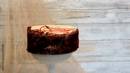 Wallpaper Mural Red velvet cake turning on a pedestal with wooden background Torontodigital.ca