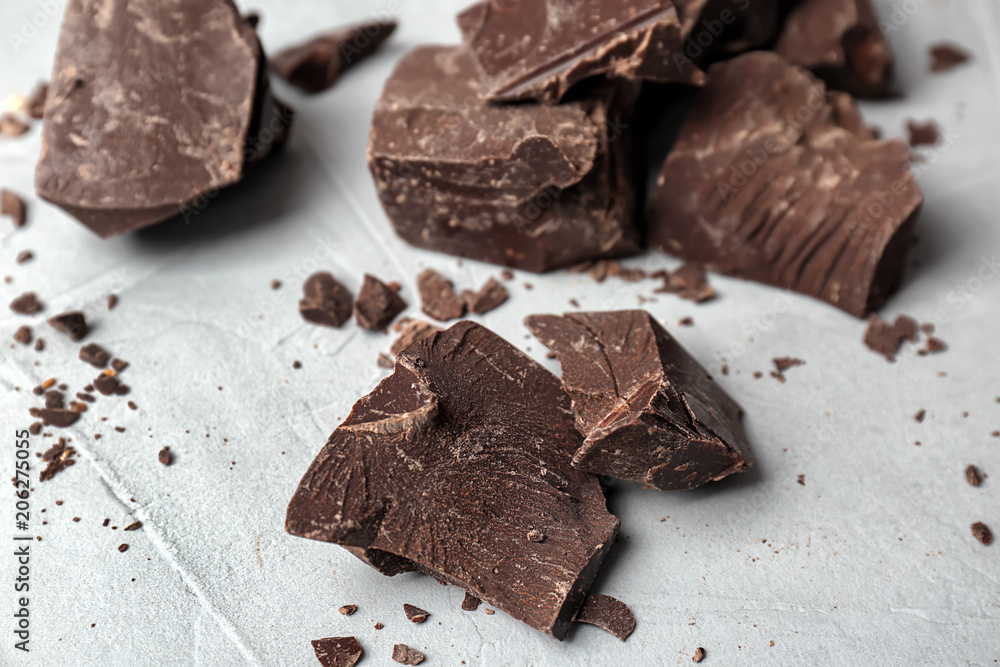 Delicious dark chocolate on grey background, closeup Delicious dark chocolate on grey background, closeup