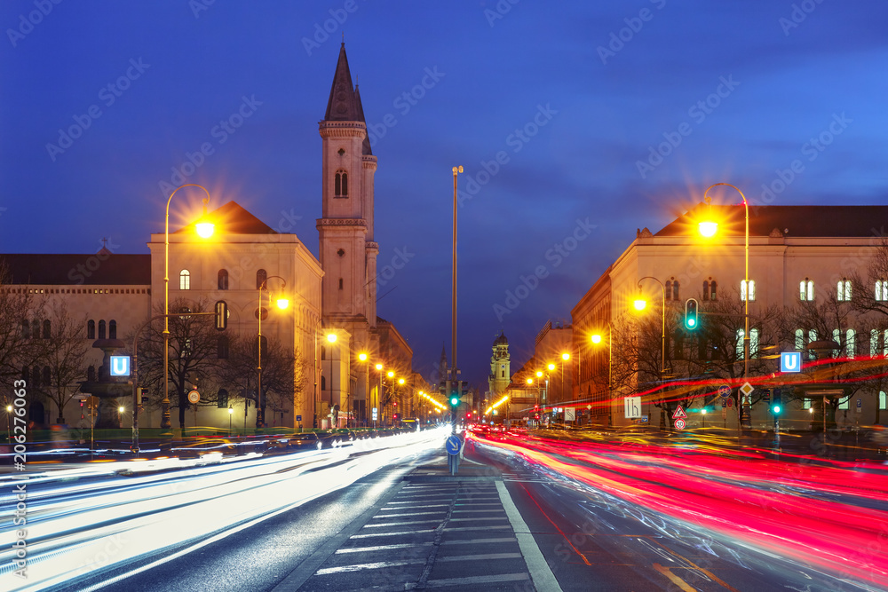 Ludwigstrasse avenue with light tracks and Church St. Louis, called Ludwigskirche, during evening blue hour in Munich, Germany