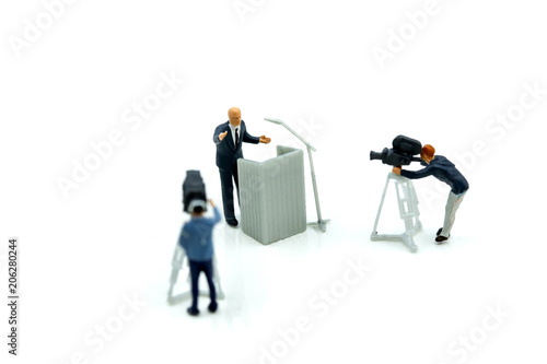 Miniature people : journalists , cameraman ,Videographer at work shooting of the campaign