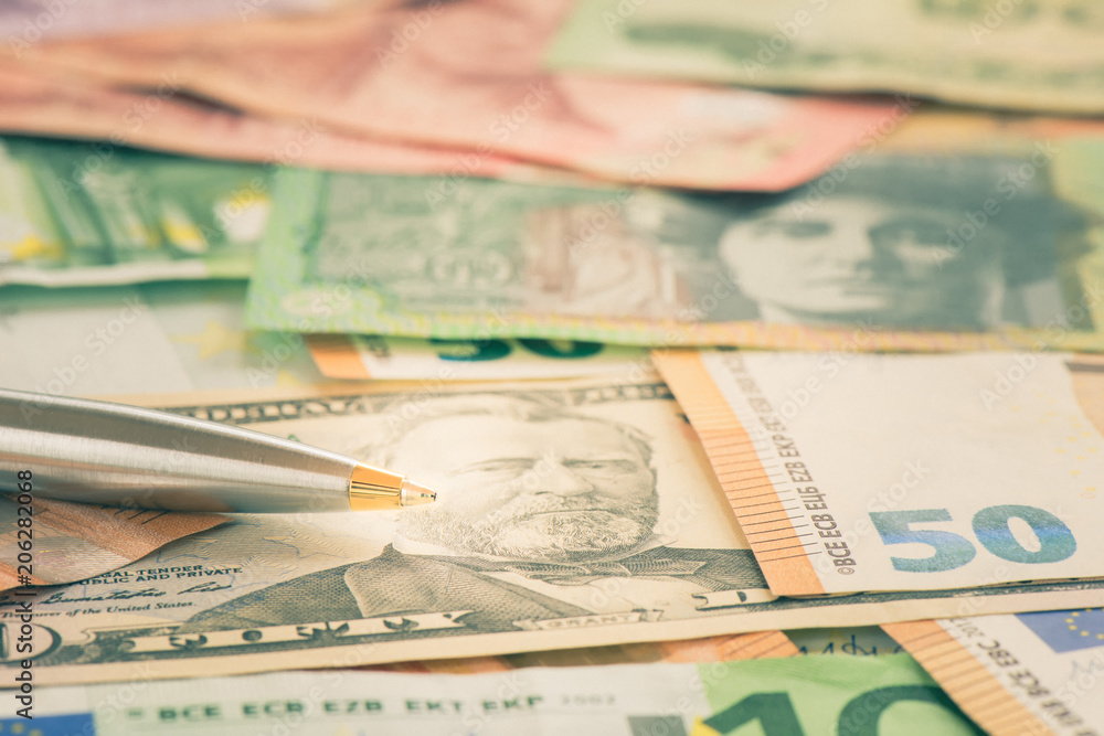 Close-up pen on USD dollar AUD and EUR bill, Business concept a pen and banknote with shallow DOF Close-up pen on USD dollar AUD and EUR bill, Business concept a pen and banknote with shallow DOF