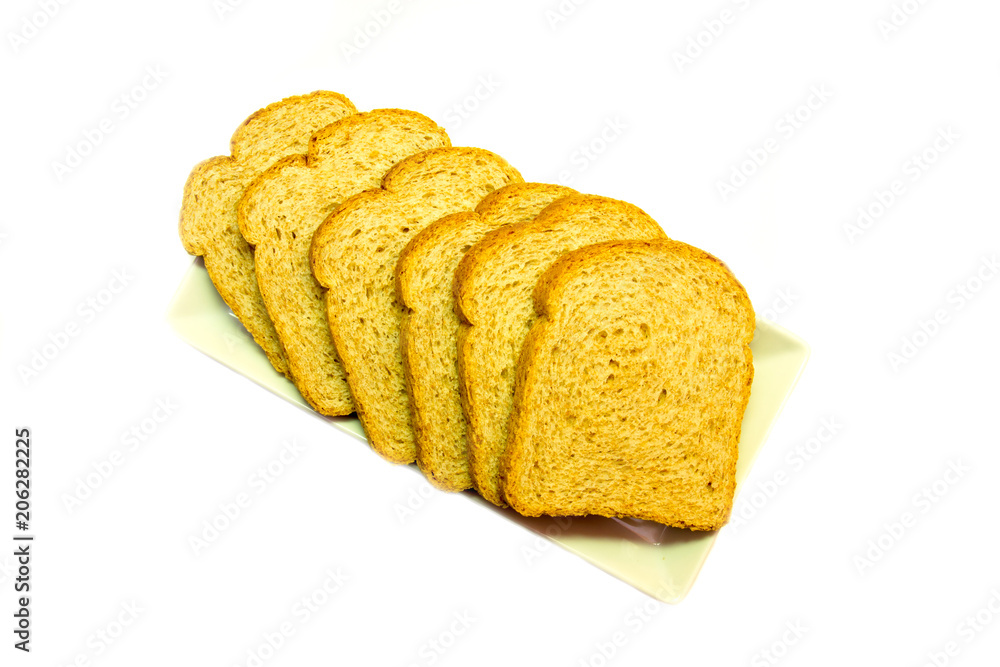 Slices of wholemeal bread on a white background viewed from above Slices of wholemeal bread on a white background viewed from above