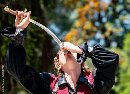 Handsome Sword Swallower Performs Act at Pirate Festival photo