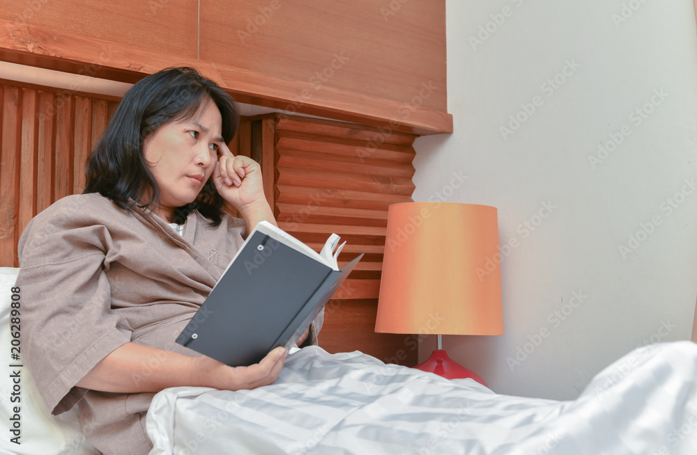 Wife thinking and read book in bedroom Wife thinking and read book in bedroom