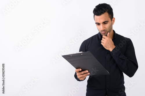 Young handsome Indian businessman against white background 