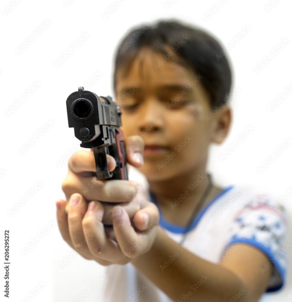 Young boy,holding a toy gun,against on a white background. Young boy,holding a toy gun,against on a white background.