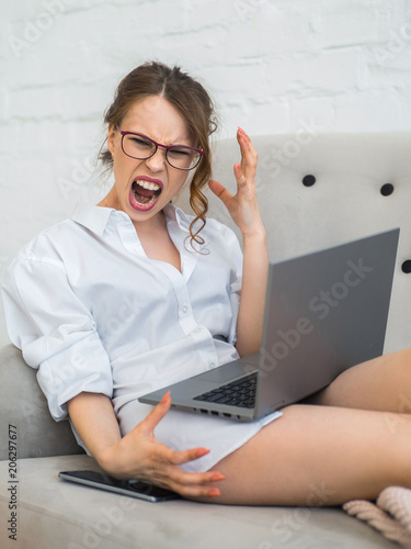aggressive career woman. Screaming and frustrated woman with laptop photo