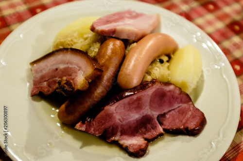 Choucroute garni, a typical alsacian plate, with sausages, bacon, choucroute and potatoes