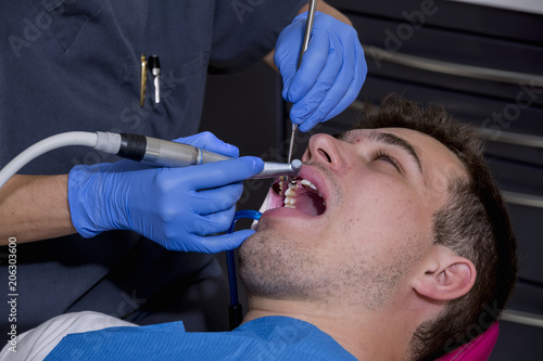Young man at the dentist  to perform a dental implant