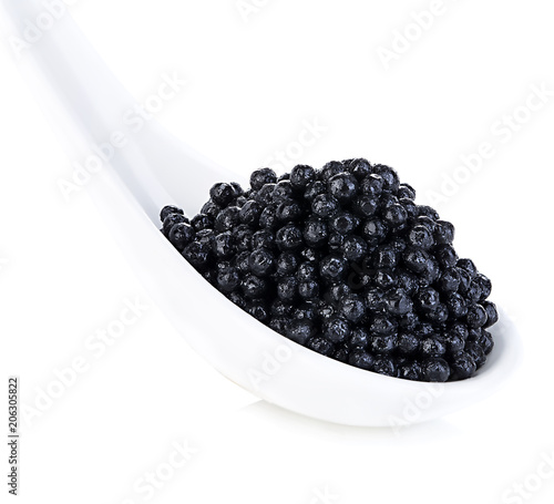 Spoon with black sturgeon caviar isolated on white background.