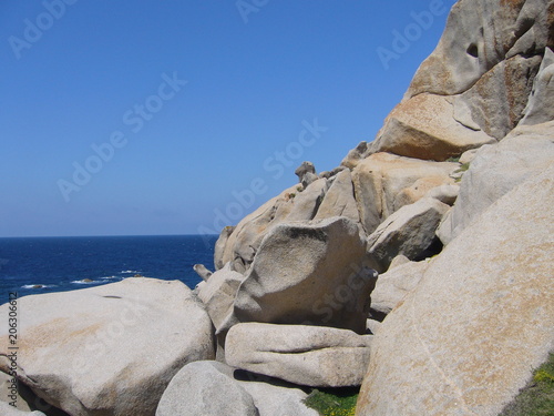 Blue sky and amazing sea, granite rocks with mediterranean vegetation, moon Valley, Valle della Luna, Capo Testa, Santa Teresa Gallura, Italy photo