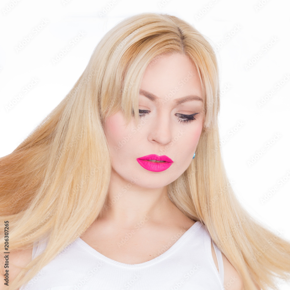 Close Up beauty portrait blonde with long hair, she with bright makeup, pink lips. Green eyes. Blue earrings. White background Close Up beauty portrait blonde with long hair, she with bright makeup, pink lips. Green eyes. Blue earrings. White background