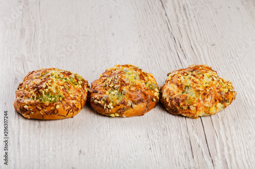 Ruddy fresh beautiful buns on a wooden background.