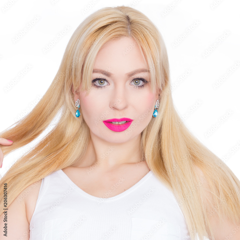 Close Up beauty portrait blonde with long hair, she with bright makeup, pink lips. Green eyes. Blue earrings. White background Close Up beauty portrait blonde with long hair, she with bright makeup, pink lips. Green eyes. Blue earrings. White background