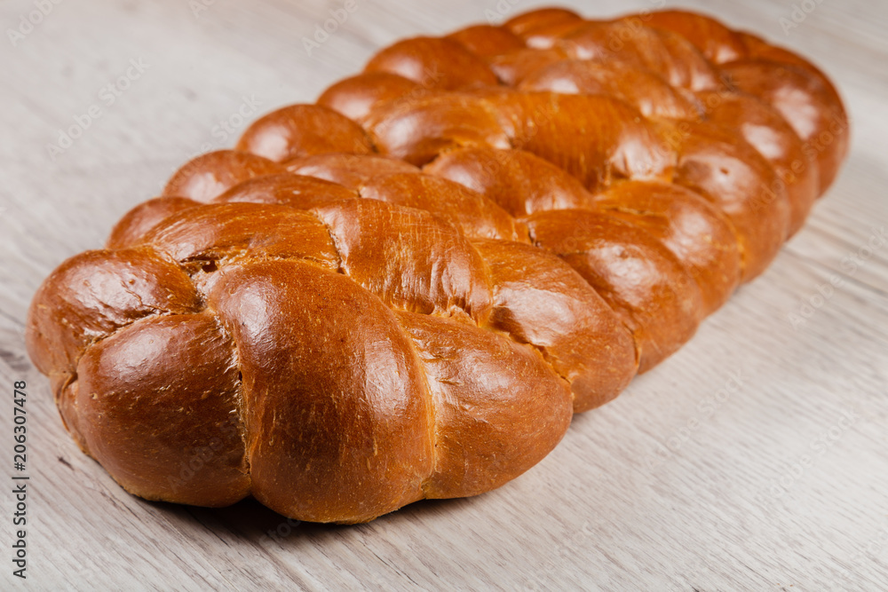 Freshly baked bread on a wooden background.