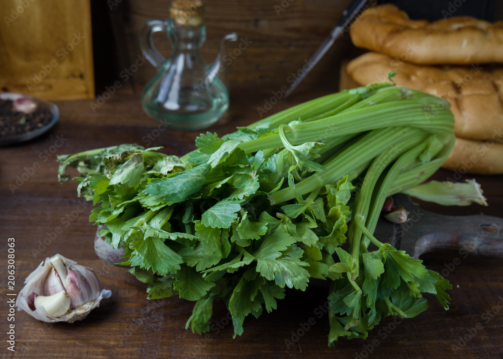 celery garlic and oil on rustic wood celery garlic and oil on rustic wood