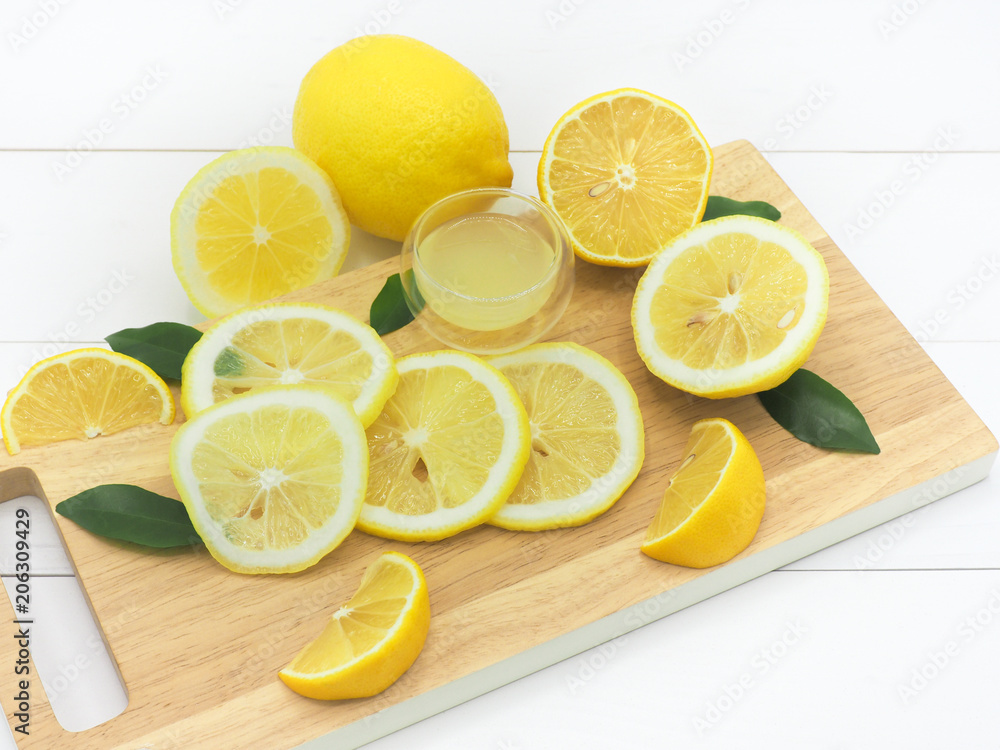 Fresh lemon slice with lemonade on white wood background Fresh lemon slice with lemonade on white wood background
