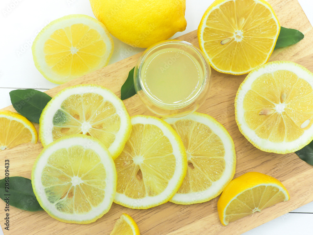 Fresh lemon slice with lemonade on white wood background