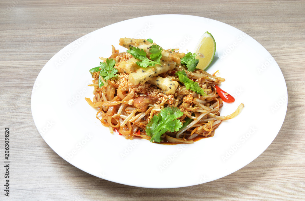  Thai style stir fried rice noodle on white plate.   