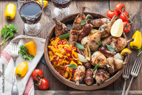 Roasted chicken with sausages and lemon. Tomatoes and wine