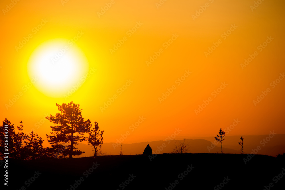 A traveler meets the dawn in the mountains of the Caucasus.