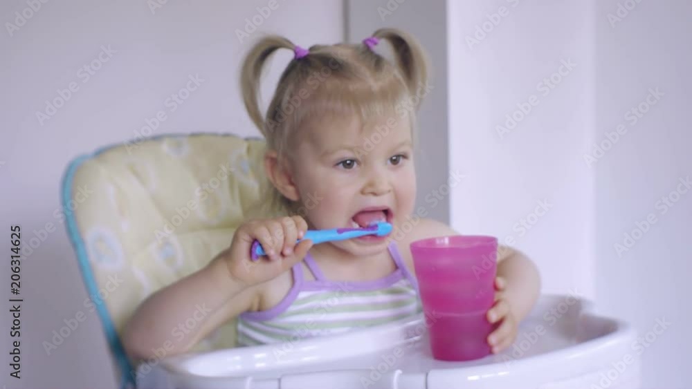 Little girl diligently brushing his teeth Little girl diligently brushing his teeth