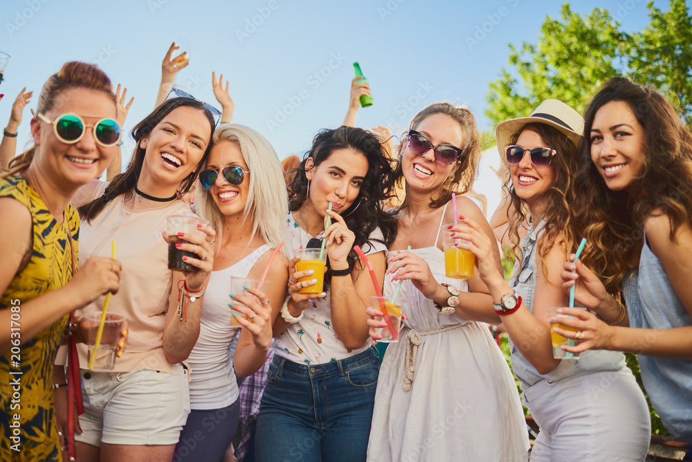 Group of female friends dancing and having a good time at the outdoor party/music festival Group of female friends dancing and having a good time at the outdoor party/music festival