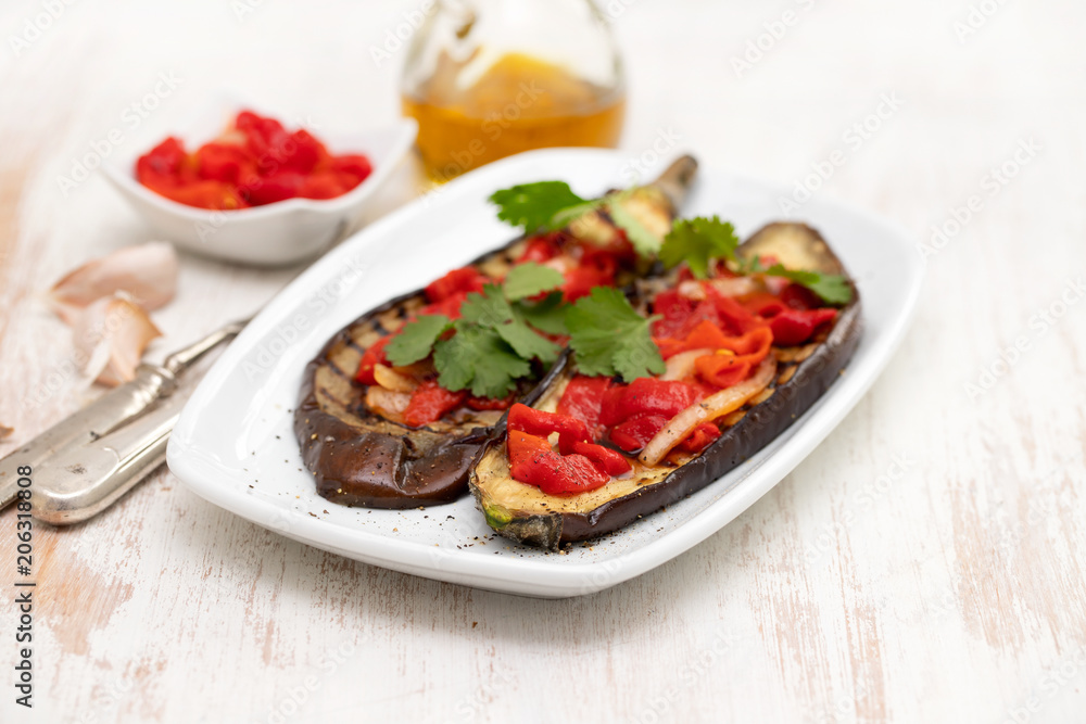 grilled eggplant with red pepper on white dish grilled eggplant with red pepper on white dish