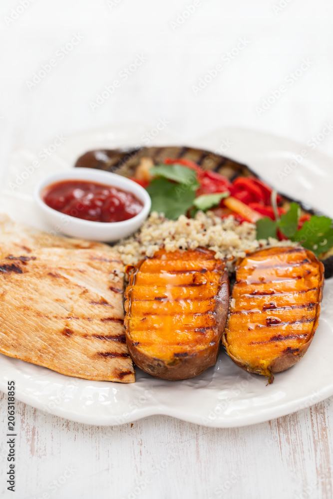 grilled chicken with vegetables and sauce on white dish grilled chicken with vegetables and sauce on white dish