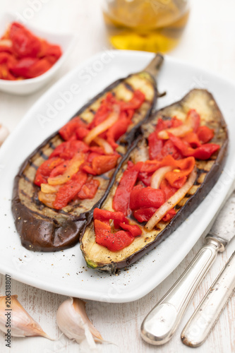 grilled eggplant with red pepper on white dish