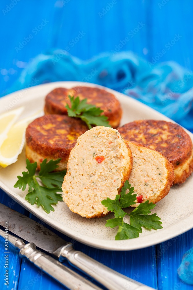 fish balls with lemon on dish on wooden background fish balls with lemon on dish on wooden background