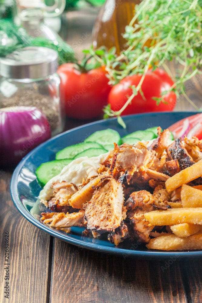Greek gyros dish with french fries and vegetables Greek gyros dish with french fries and vegetables