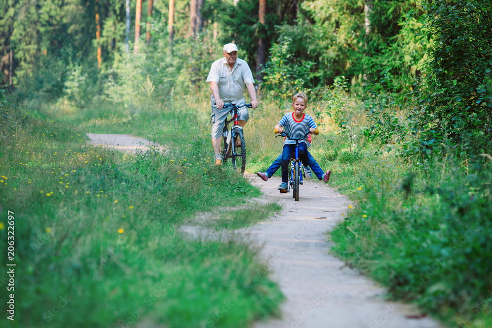 Obraz premium active senior with grandkids riding bikes in nature