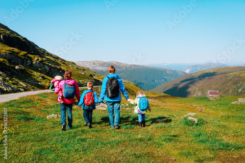 family with kids hiking in mountains, active travel